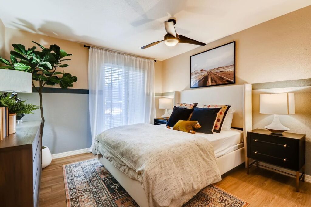 staged bedroom with large window and ceiling fan