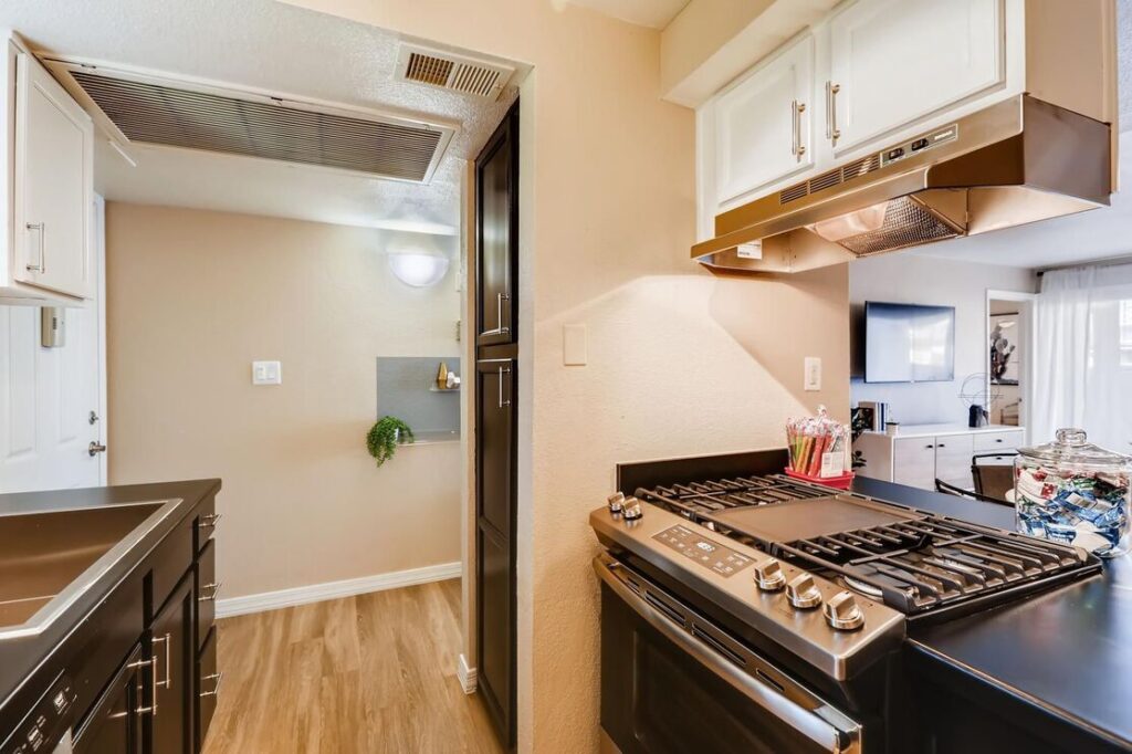 kitchen with a gas stove and view into living room