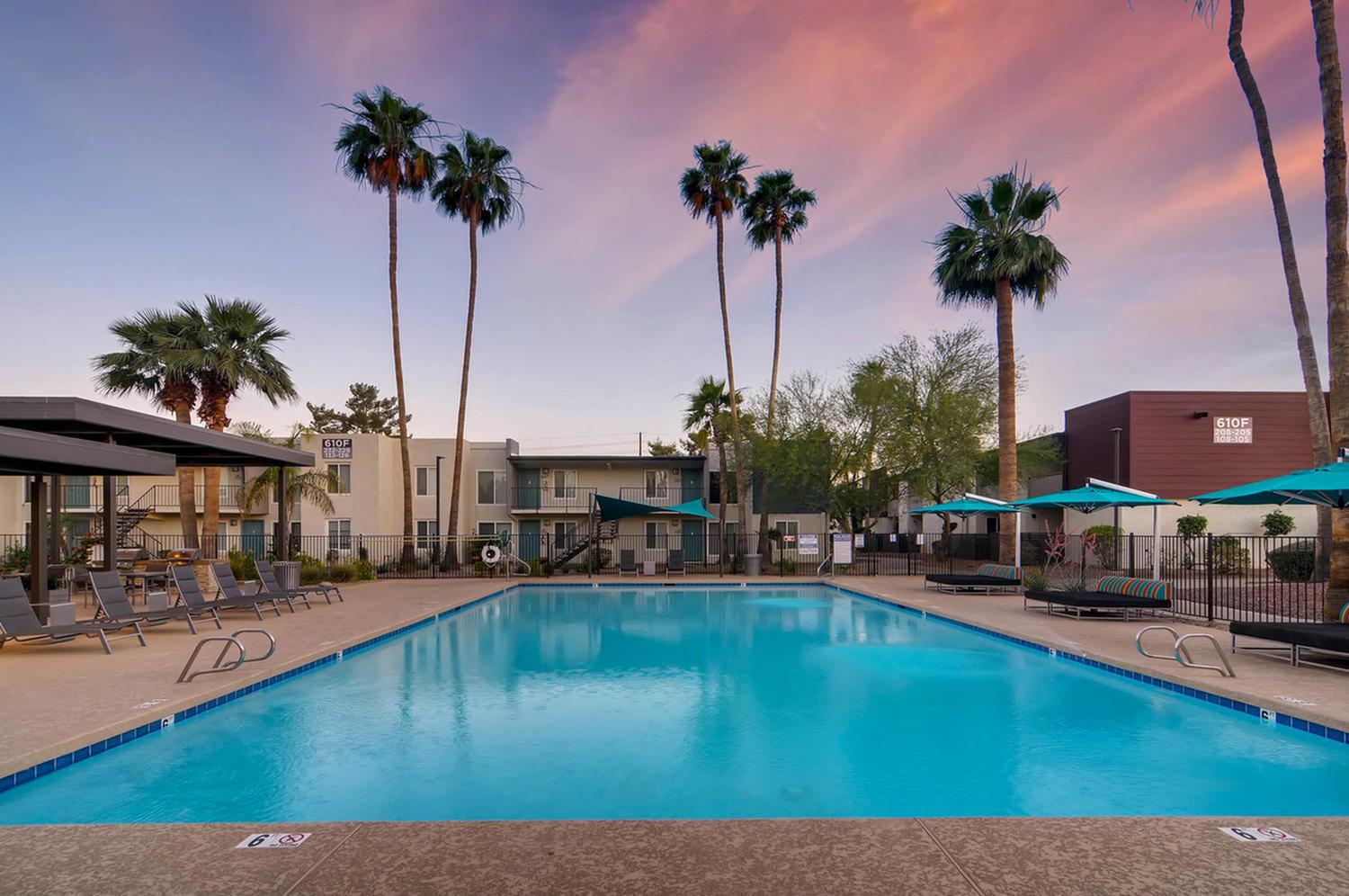 Swimming pool with seating at Scottsdale Gateway apartments near Old Town Scottsdale