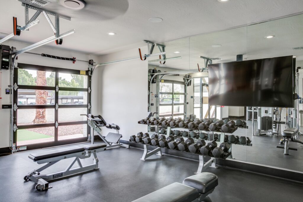 fitness center with free weights and TV