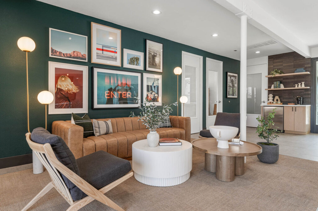 An interior view of the leasing office at the Scottsdale Gateway pet-friendly apartments in Tempe, Arizona featuring various couches, center tables, wall artwork and plants